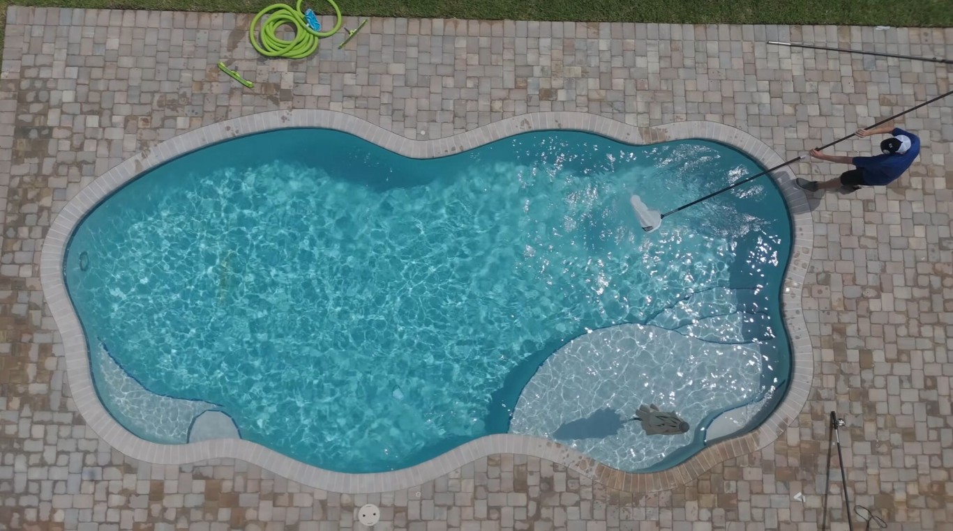Professional pool cleaning service showing crystal clear blue pool in Lakewood, CA